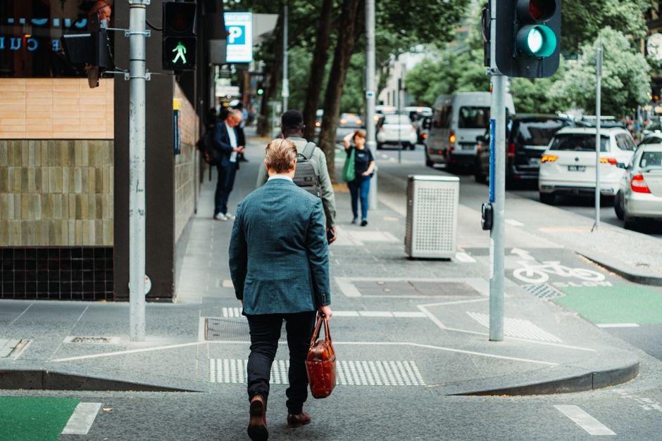 Businessman Crossing Busy City Street